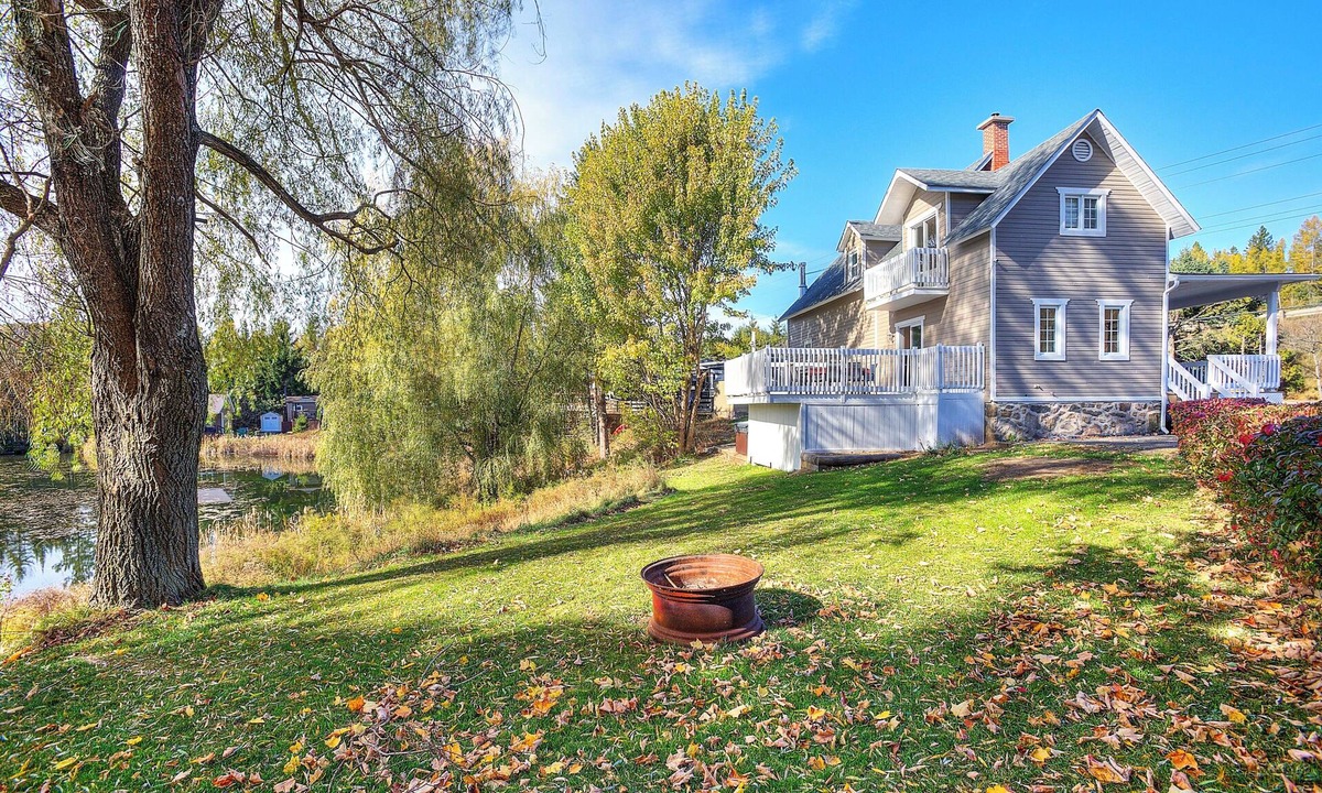 Mont-Tremblant House | Escape to our 100-year-old ancestral home on 23 private acres by Lac Jolicoeur. This lakefront retreat is perfect for large groups of up to 15, offering year-round magic with a private hot tub, stone fireplace, and game room.