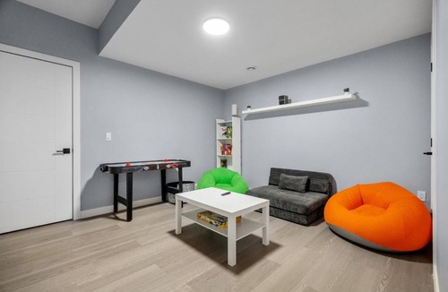Airdrie Apartment | 1BR Entertainment Space Projector and Games Room