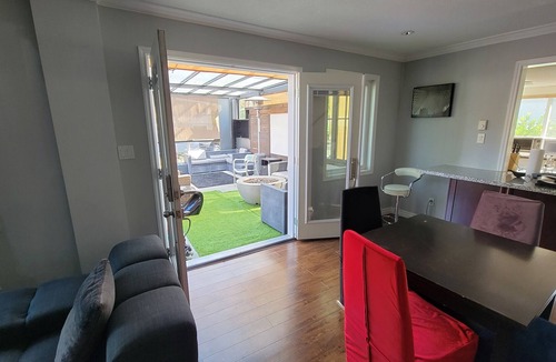 Burnaby House | 8 minute walk to skytrain Central Great covered outdoor seating with fire table.
