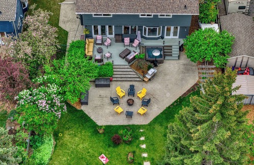 Northwest Calgary House | Almost 1/2 an acre on the Bow River, huge fenced yard, hot tub, firepit, games!