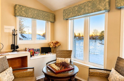 Lagoon City Cottage | Canalside summer cottage w/river views, fire table & outdoor cushioned seating