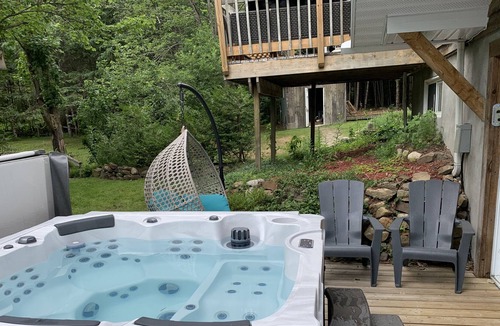 Rawdon House | Chalet du Ruisseau Rawdon hot tub outside inside fireplace for up to 16 people