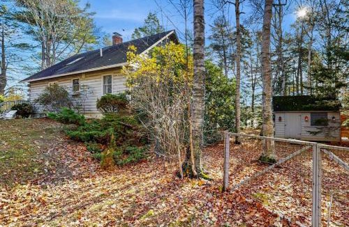Wiscasset House | Charming riverfront home with cozy interiors, dock, and scenic deck views