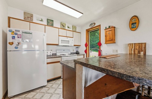 Rangeley Plantation House | Stone - This Rangeley Lake home has a very level entry to the water with a huge deck!