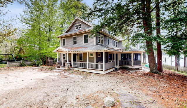 Captivating waterfront home with private dock & beach, lake views