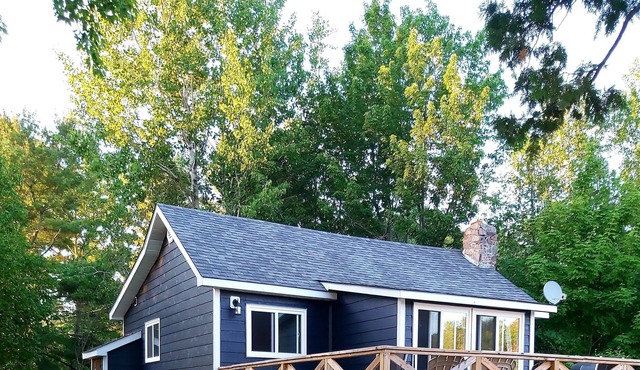 cozy lakefront cottage with firepit and boat dock