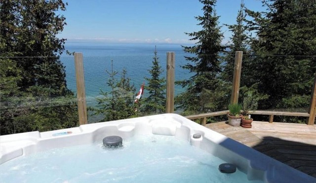 Marvel at breathtaking views surrounding you from this waterfront chalet
