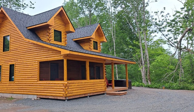 Private lakefront log cabin with year-round hot tub.