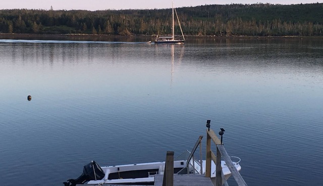 Private self contained cottage with terraced decking right to the water.