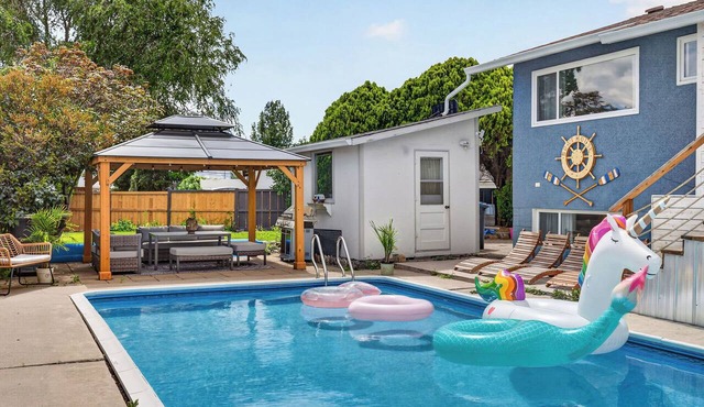 Relax at a central Kelowna pool house with a private backyard oasis, outdoor bar & spacious layout over two levels. Walk or take a short drive to downtown cafés, shops, beaches & wineries, then come home to a quiet, stylish space.
