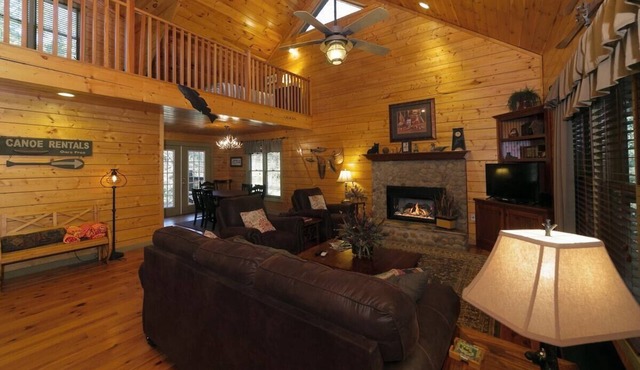 Riverfront 3BR cabin with hot tub, game room, and fishing