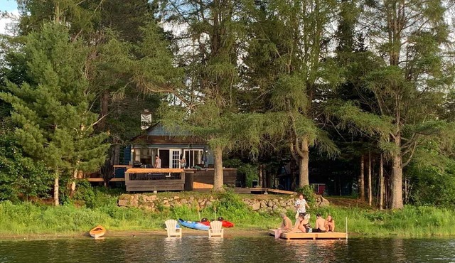 Waterfront cottage with private spa, blending rustic and contemporary charm.